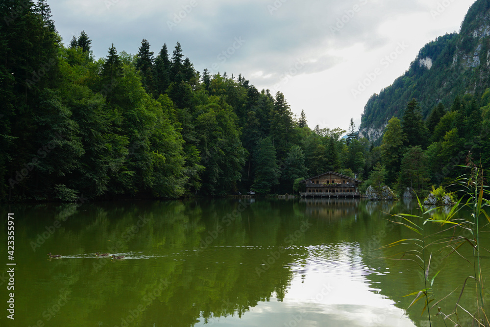 Log house on the lake surrounded by mountains in Austria