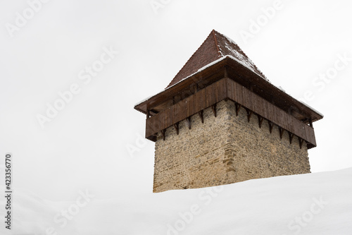 A Fortification Tower Partially Hidden by Snow on a Cloudy Late-Winter Day