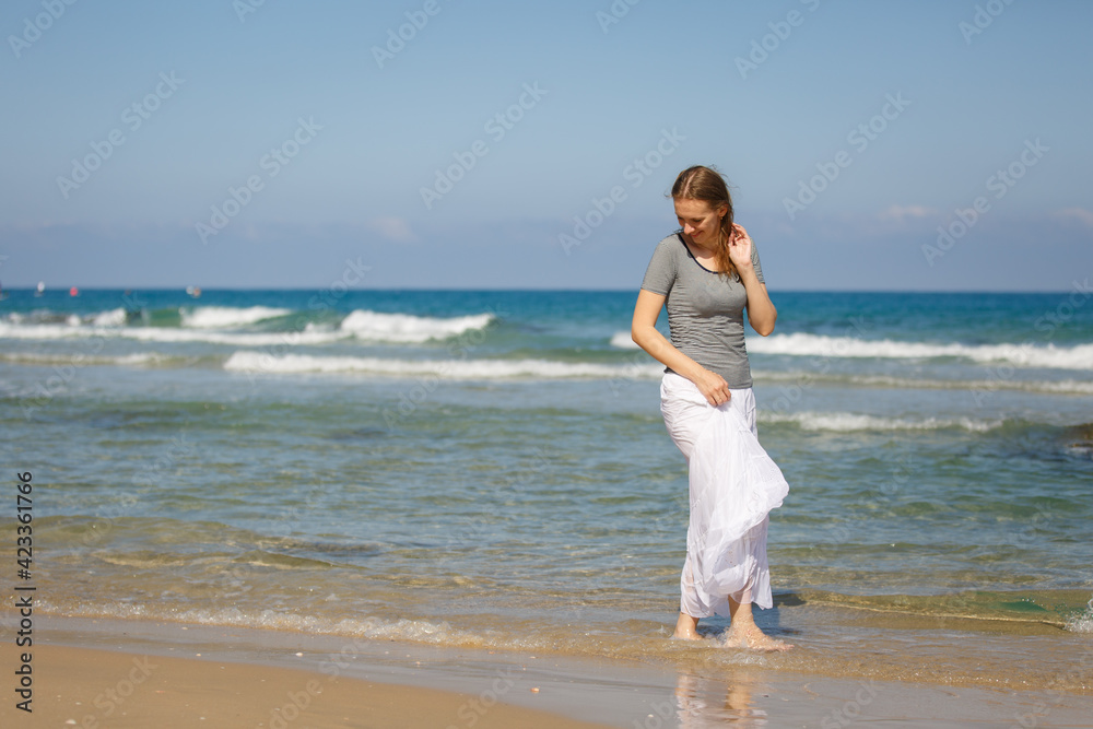 Young woman on a sea or ocean beach in marine outfit. Tropic vacation. Sea relax and rest. Spending a time on beach. Enjoying Happy time. Smiling female in lagoon. Summer holiday local tourism Young woman on a sea or ocean beach in marine outfit. Tropic vacation. Sea relax and rest. Spending a time on beach. Enjoying Happy time. Smiling female in lagoon. Summer holiday local tourism