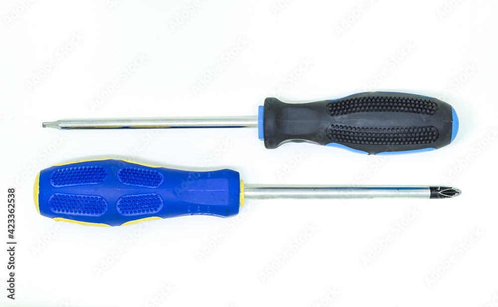 Two tool screwdrivers lie parallel on a white isolated background Two tool screwdrivers lie parallel on a white isolated background