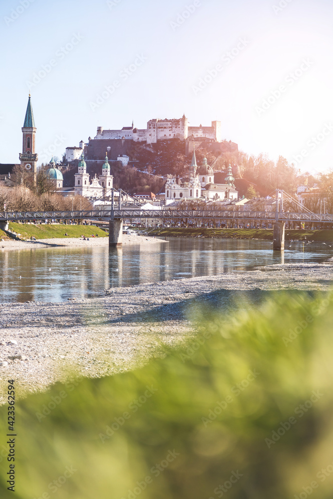 Salzburg spring time: Panoramic city landscape with Salzach with green grass and historic district