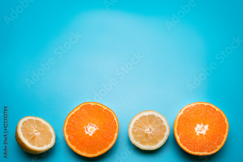 Fruits on the blue background. Orange  lemon. Free space for text.