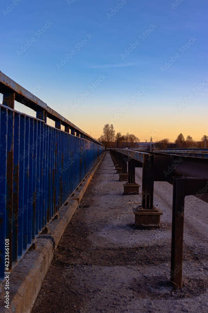 blue rusty railings converging at the horizon line