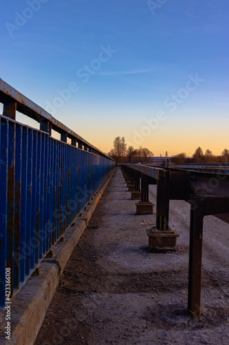 blue rusty railings converging at the horizon line