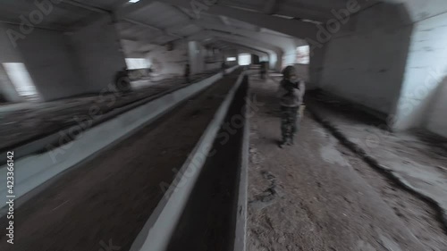 Wallpaper Mural Group of people in masks and military uniforms are engaged in airsoft in an abandoned building. FPV drone shooting Torontodigital.ca