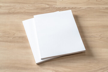 Book cover mockup with blank white front paper page a4 paperback mock up for catalog, magazine, menu, booklet, notebook, portfolio design template on wood table background