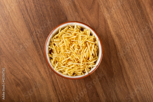 Straw potato in bowl on wooden background. Top view image.