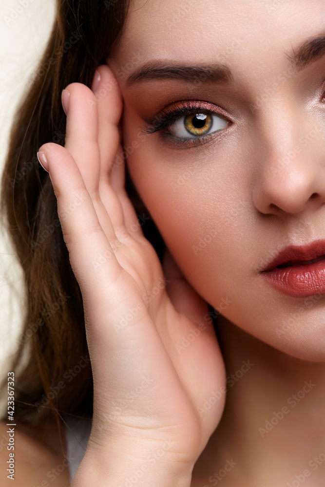 Beauty portrait of young woman. Brunette girl with evening female makeup. Beauty portrait of young woman. Brunette girl with evening female makeup.