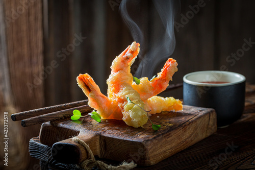 Tasty shrimp in tempura with red sauce. Old Chinese cuisine.