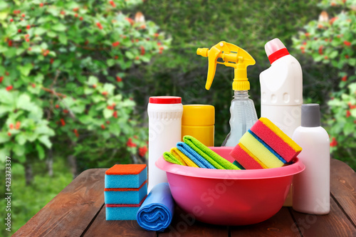 Cleaning products on a wooden table in the garden.