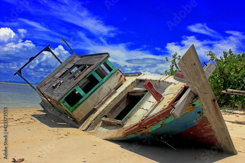 wooden boat that was stranded on the shore