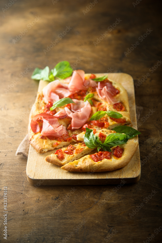 Homemade focaccia with tomatoes and ham
