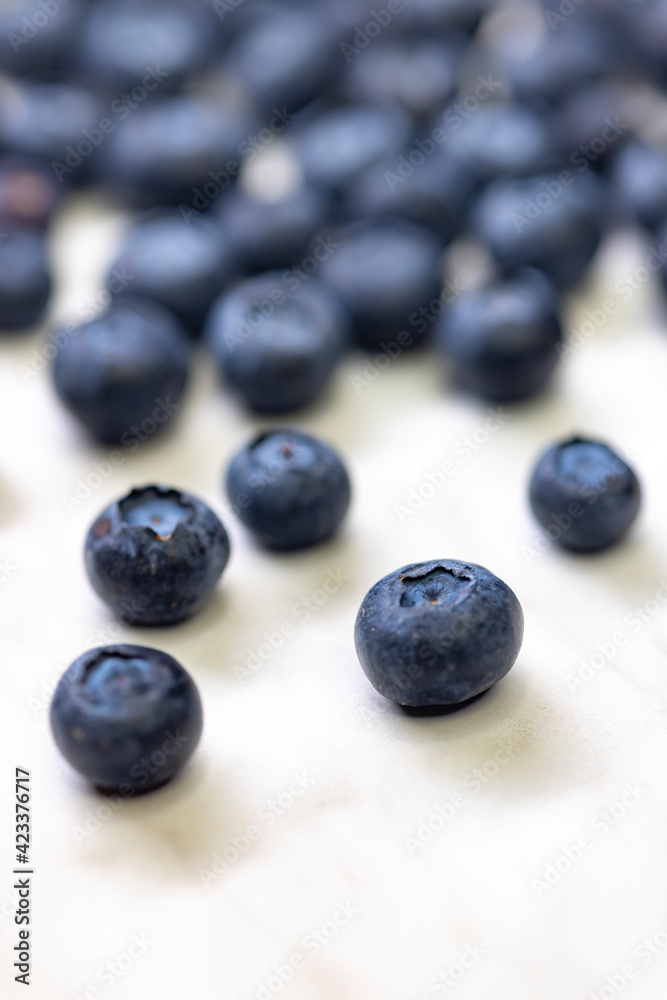 still life with blueberries on a white patterned background still life with blueberries on a white patterned background
