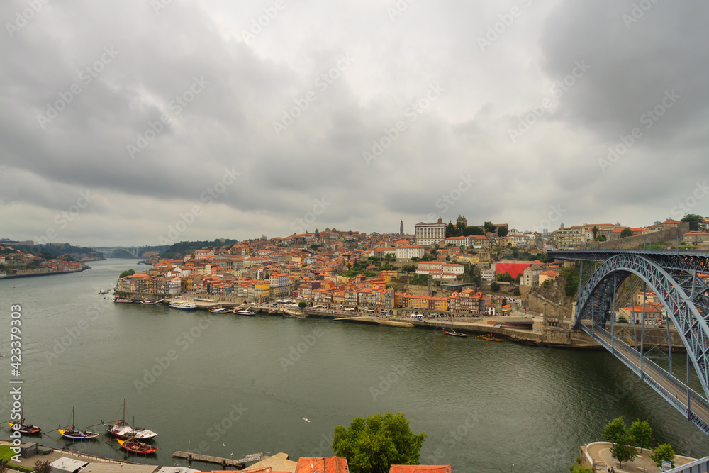 Oporto, Portugal, Europe. Postcard from the picturesque city of Porto, amazing travel destination in Portugal. View to the historic center of the city, Douro River with its beautiful bridge.