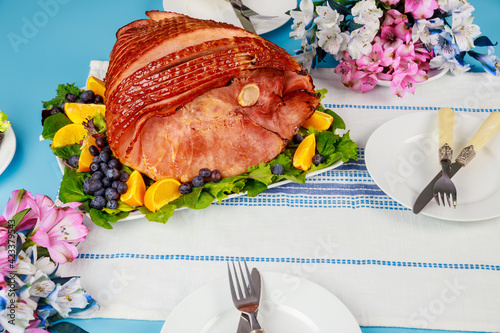 Hickory smoked sliced ham on festive table.