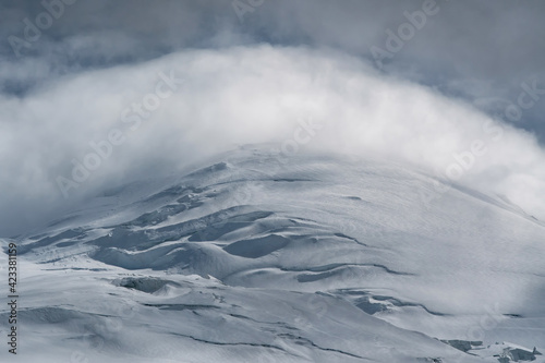 Clouds flowing through the summit of Elbrus. Prielbrusye National Park, Kabardino-Balkaria, Caucasus, Russia. © Kirill