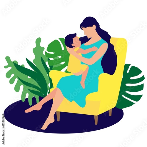 A young mother with a baby in her arms sits in a chair. Motherhood. Natural background with leaves and plants.