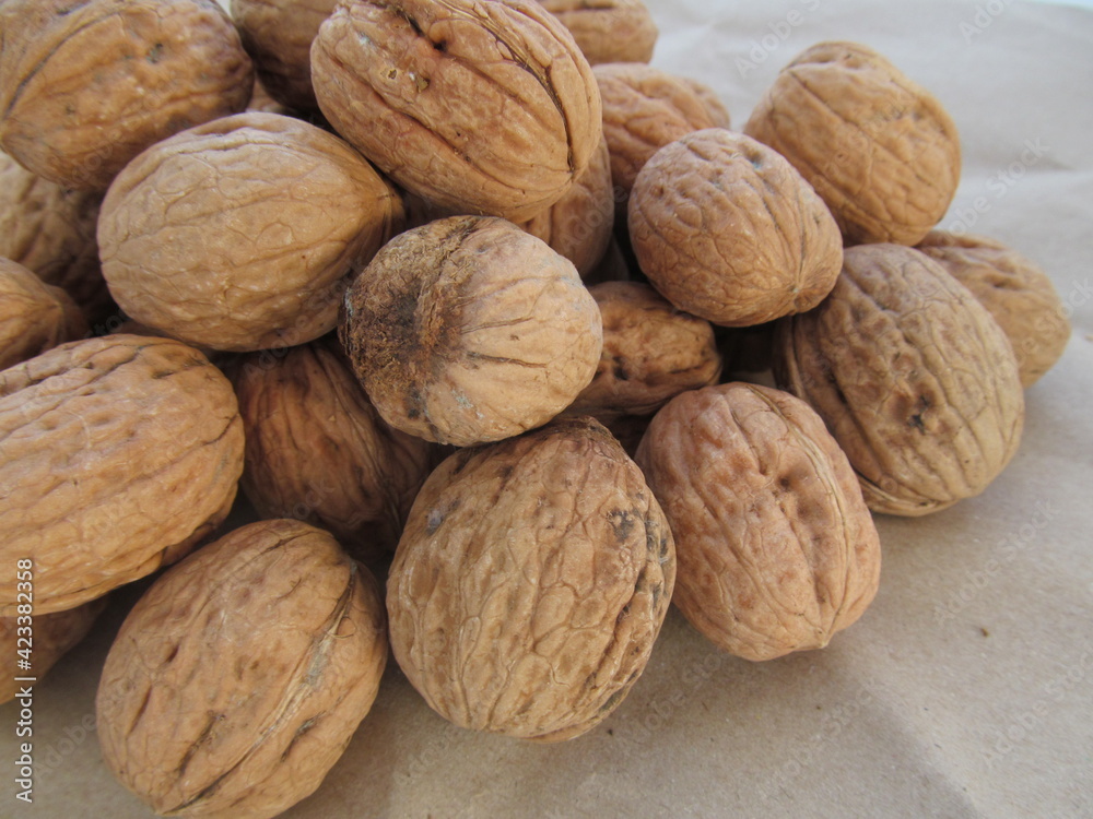 Natural walnuts in a wooden shell. Photographed close-up. Natural walnuts in a wooden shell. Photographed close-up.