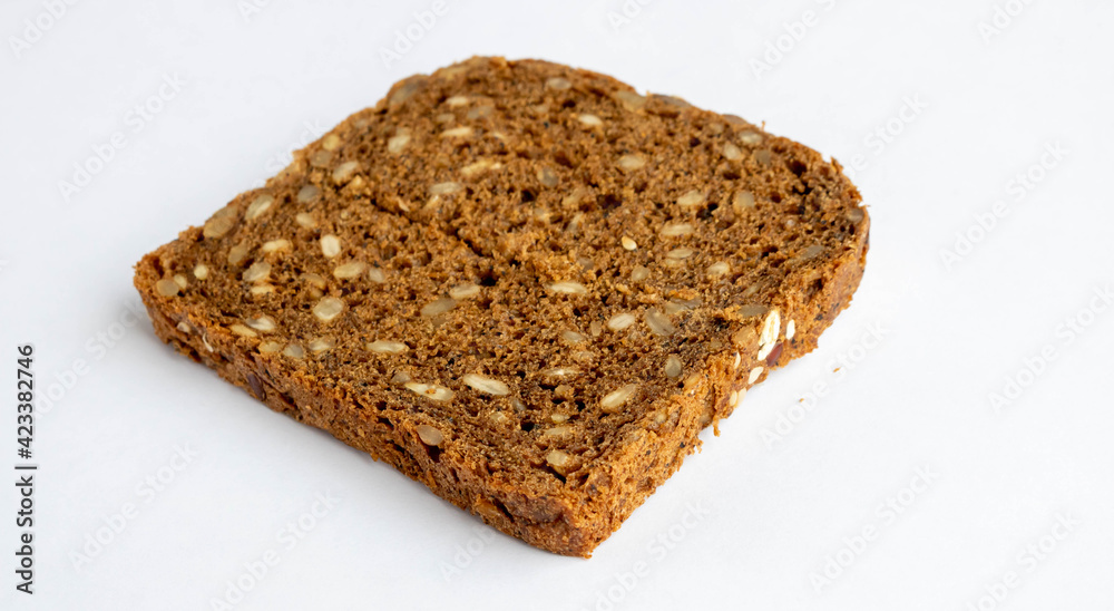 Slice of whole-grain dark bread, isolated on a white background close-up Slice of whole-grain dark bread, isolated on a white background close-up