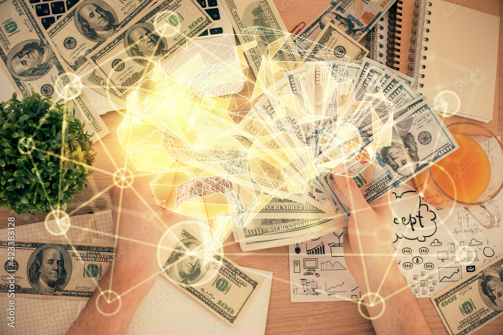Multi exposure of brain drawing hologram and us dollars bills and man hands. Ai invest concept Multi exposure of brain drawing hologram and us dollars bills and man hands. Ai invest concept