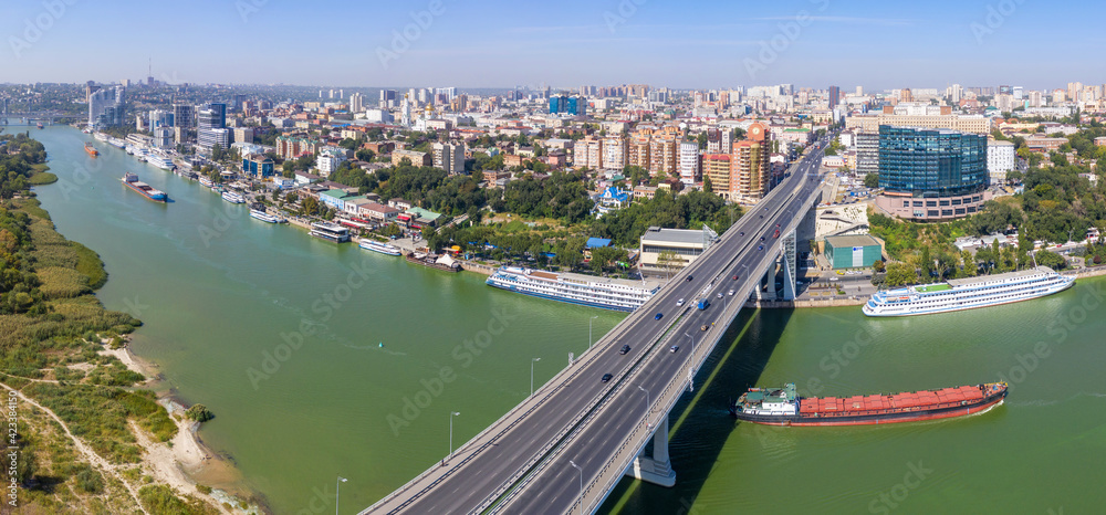 Panoramic aerial view of Rostov-on-Don, barges floating on Don river and bridge across the river. Rostov oblast, Russia.