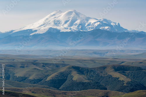 View of Mount Elbrus from Bermamyt plateau on sunny summer day. Karachay-Cherkessia, Caucasus, Russia.