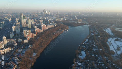 sunset over the city, tall skyscrapers, urban contrast, winter cityscape, drone shooting of the city