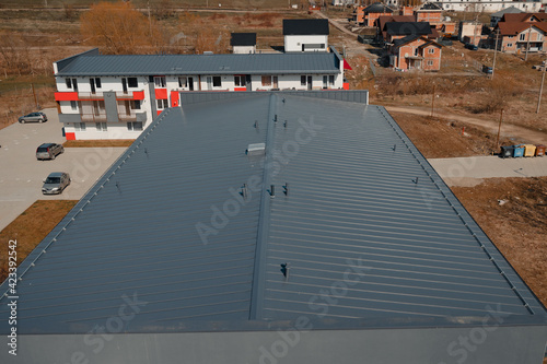 New tin roof on the apartment building. Watterproof roofing system photo