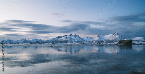 Amazing seascape with snowy mountains at sundown