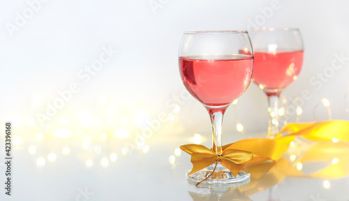 Pink wine in glasses on a light background and a place for text.