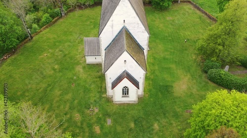 Muhu Island in the Baltic sea, Saare County, Estonia. Beautiful 4K panoramic aerial video from flying drone to Muhu St. Catherine's Church, (Muhu Katariina kirik) on a sunny summer day. (Series) photo