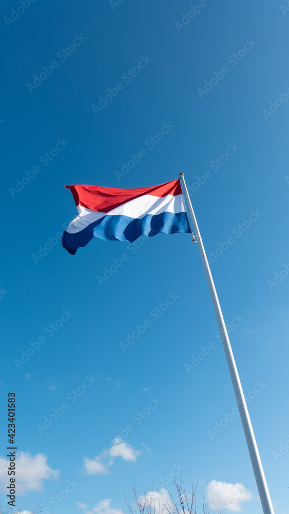 Dutch flag on blue sky