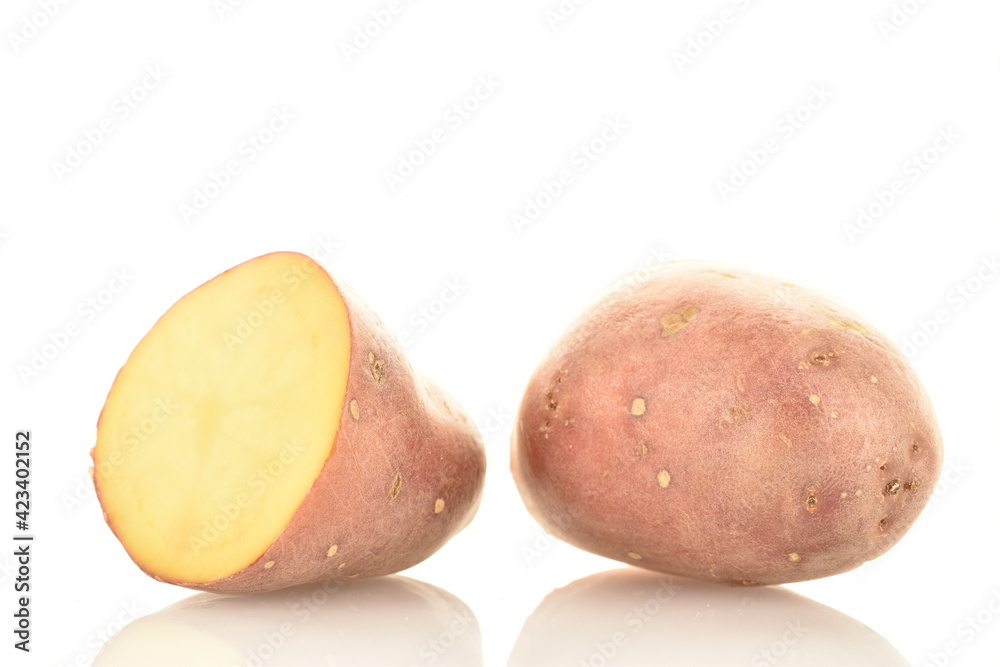 Two halves of unpeeled raw potatoes, close-up, isolated on white.