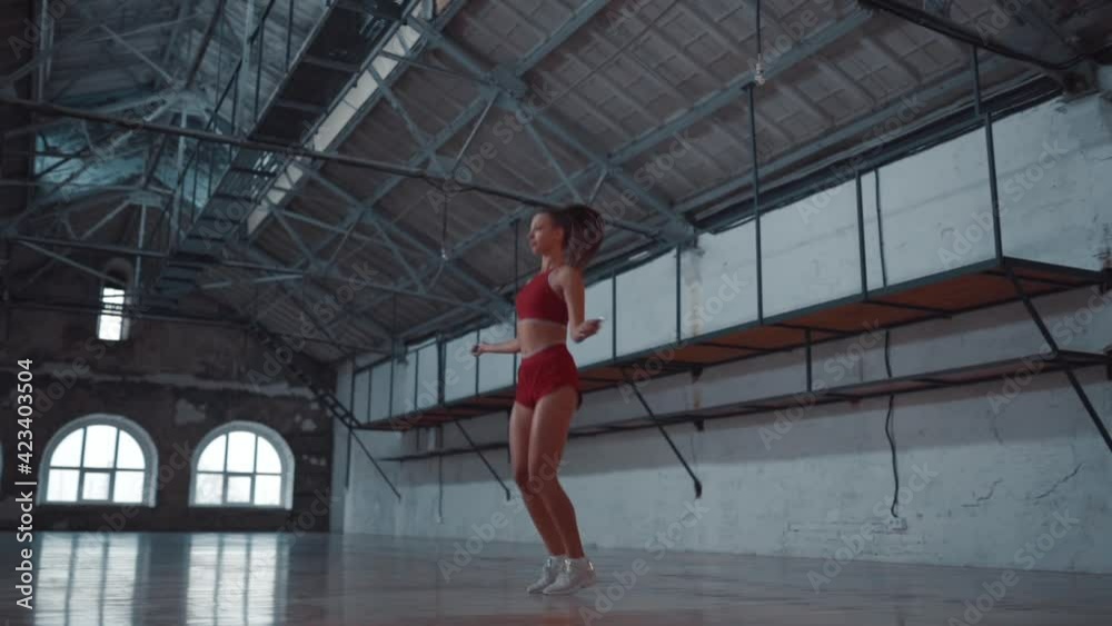 Beautiful woman in sportswear is jumping rope in the gym. Healthy lifestyle. Sports activities. Beautiful woman in sportswear is jumping rope in the gym. Healthy lifestyle. Sports activities.