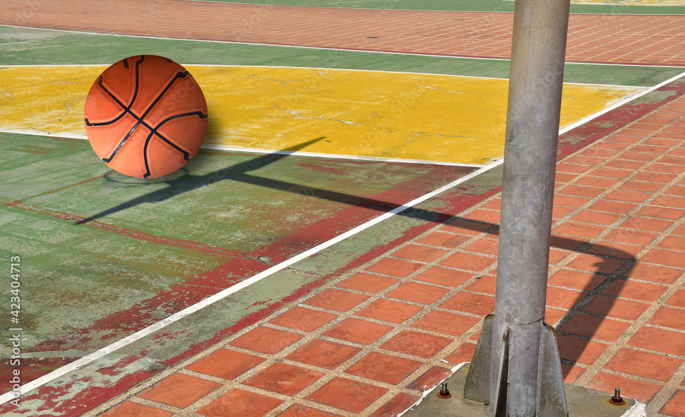Basketball balls are placed on the basketball hoop's shadow on the