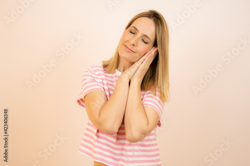 Portrait of a young woman standing and sleeping isolated over white background