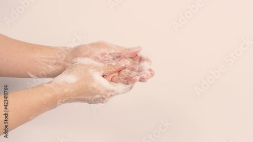 Hand wash gesture with foaming hand soap on white background.copy space