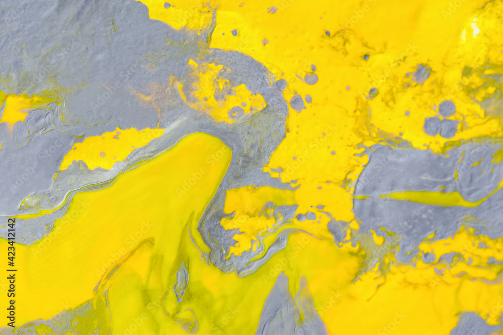 Abstract gray-yellow art background with acrylic paints. Fluid artistic texture. The trending colors of 2021 are extremely gray and bright. Modern background of mixed colors for website design