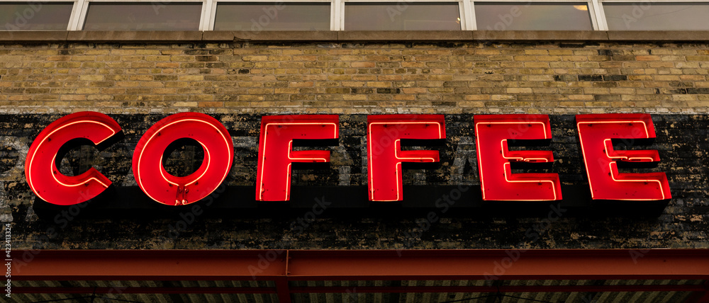A red neon sign that spells out COFFEE