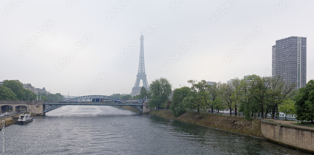  View of the Grenelle Bridge. On the embankment are moving cars and pedestrians, along the river-ship