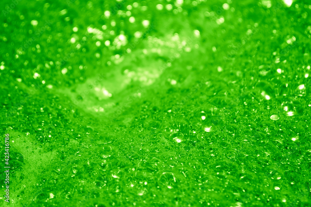 Green foam. Foam texture as background. Background and texture concept. Close up of bubbling green foam
