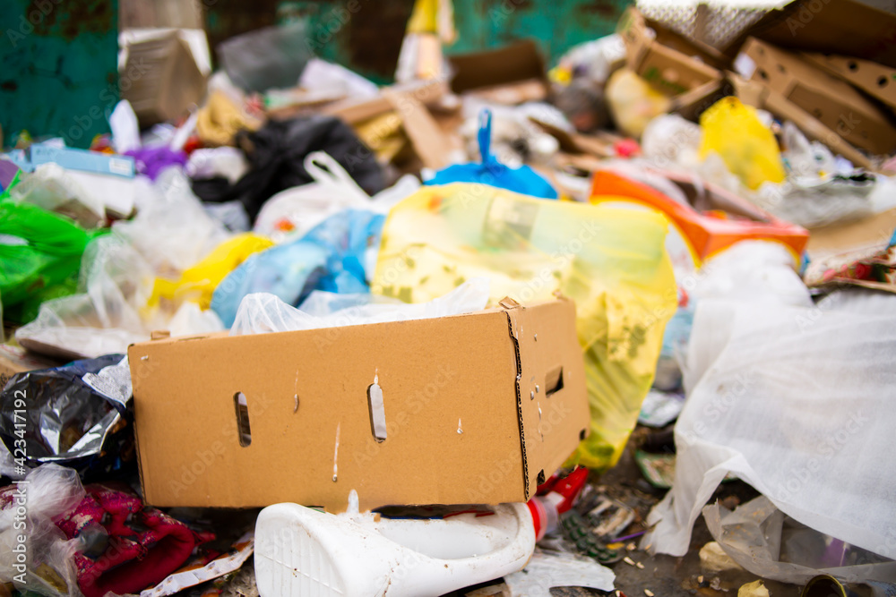 A pile of garbage in a landfill and an abundance of waste, trash and pollution of plastic bottles and bags on the ground, recycling of waste and the danger of toxic environmental poisoning.