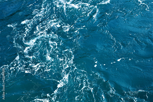 Marbled blue deep ocean rippled water surface