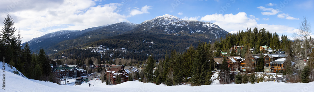 Panoramic View of Chalets and Vacation Homes in a Village at a Famous Ski Resort with Mountains Landscape in Background. Whistler, British Columbia, Canada.