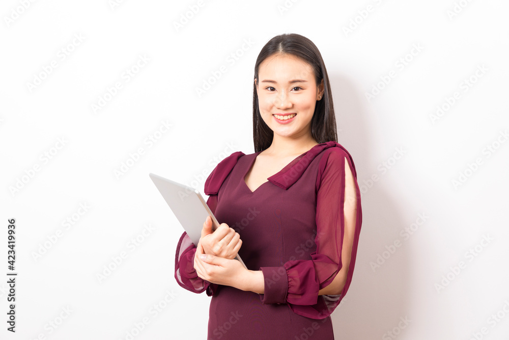 Happy beautiful asian business woman using tablet isolated on white background. Happy beautiful asian business woman using tablet isolated on white background.