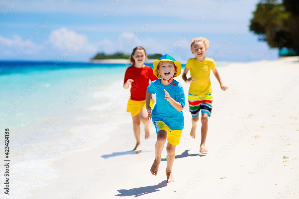 Kids playing on beach. Children play at sea.