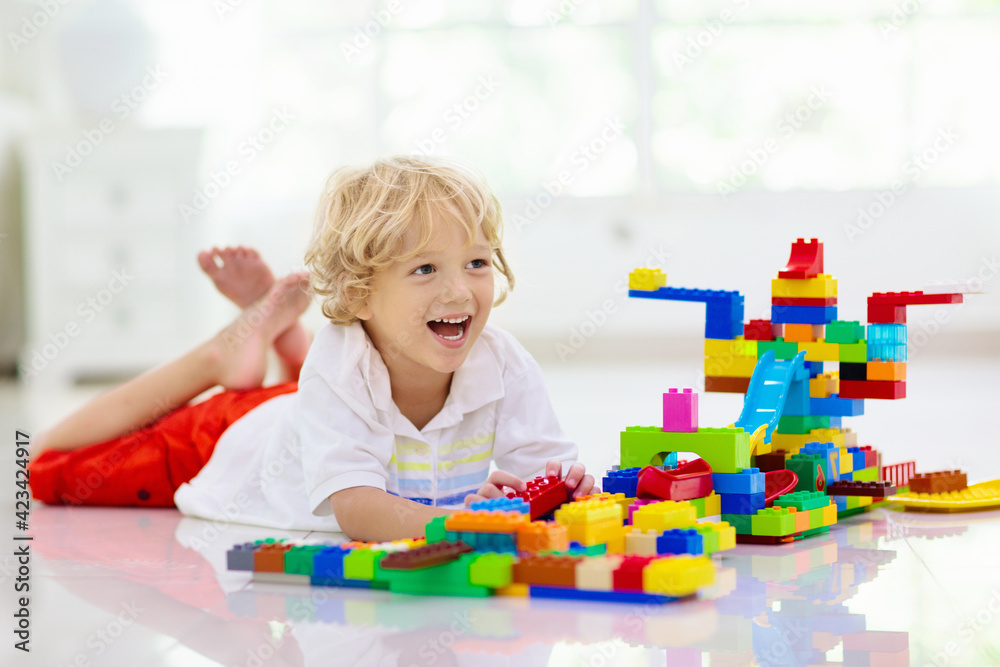 Child playing with toy blocks. Kids play. Child playing with toy blocks. Kids play.