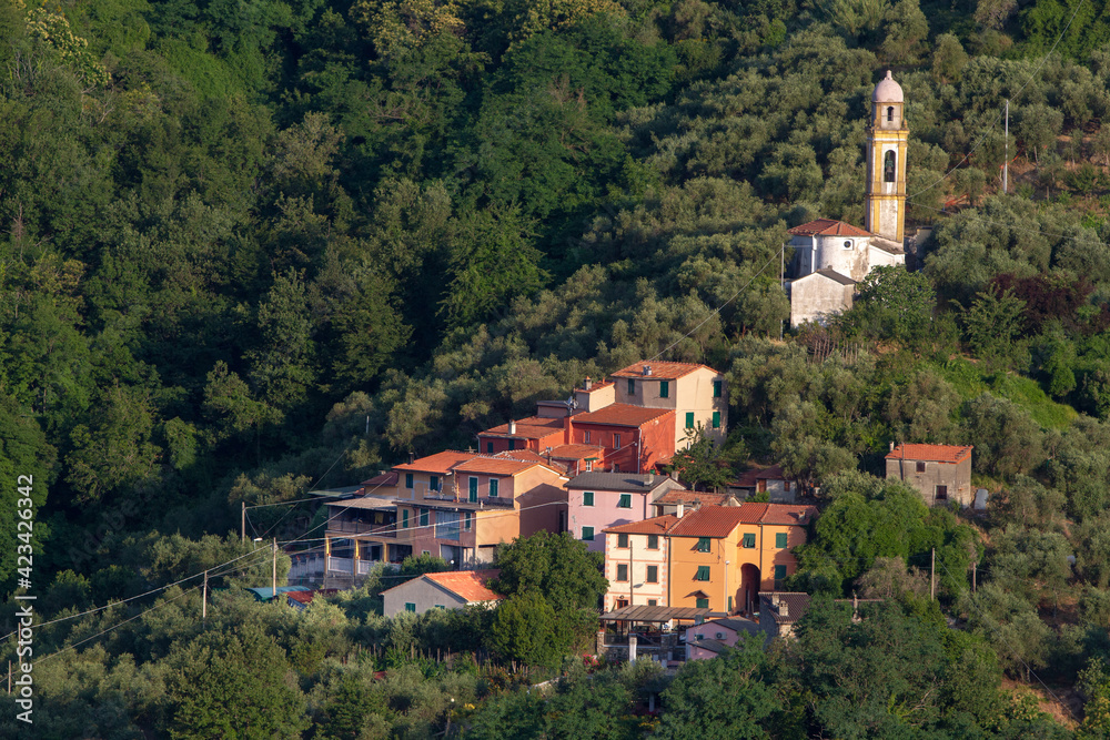Wonderful view of the Italian village in the mountains. Temples and houses among the greenery.