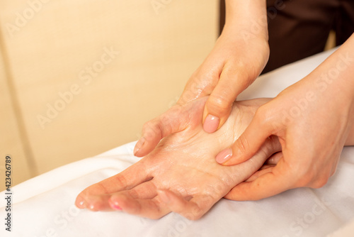 Closeup massage of female hands by physiotherapist. Carpal tunnel syndrome, arthritis, neurological disease concept. Numbness of the hand. Hand massage. © Arina