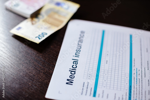 medical insurance application with money banknotes. Stethoscope and health insurance form. claim form. 